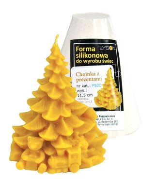 A silicone mould in the shape of a Christmas tree with presents, alongside a candle made using the mould.