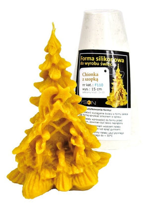 Beeswax Christmas tree with nativity scene at the bottom next to a white silicone candle mould against a white background.