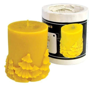 A silicone mould with a Christmas tree pattern, used for making small beeswax candles, displayed next to its packaging.