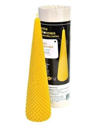 A silicone mould with a Christmas tree engraving, displayed next to a cylindrical wick, against a white background.