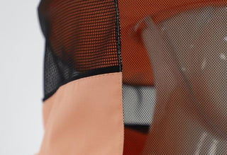 Close-up of salmon and black coloured beekeeping hat which is paired with the full-length beekeeping overalls. 